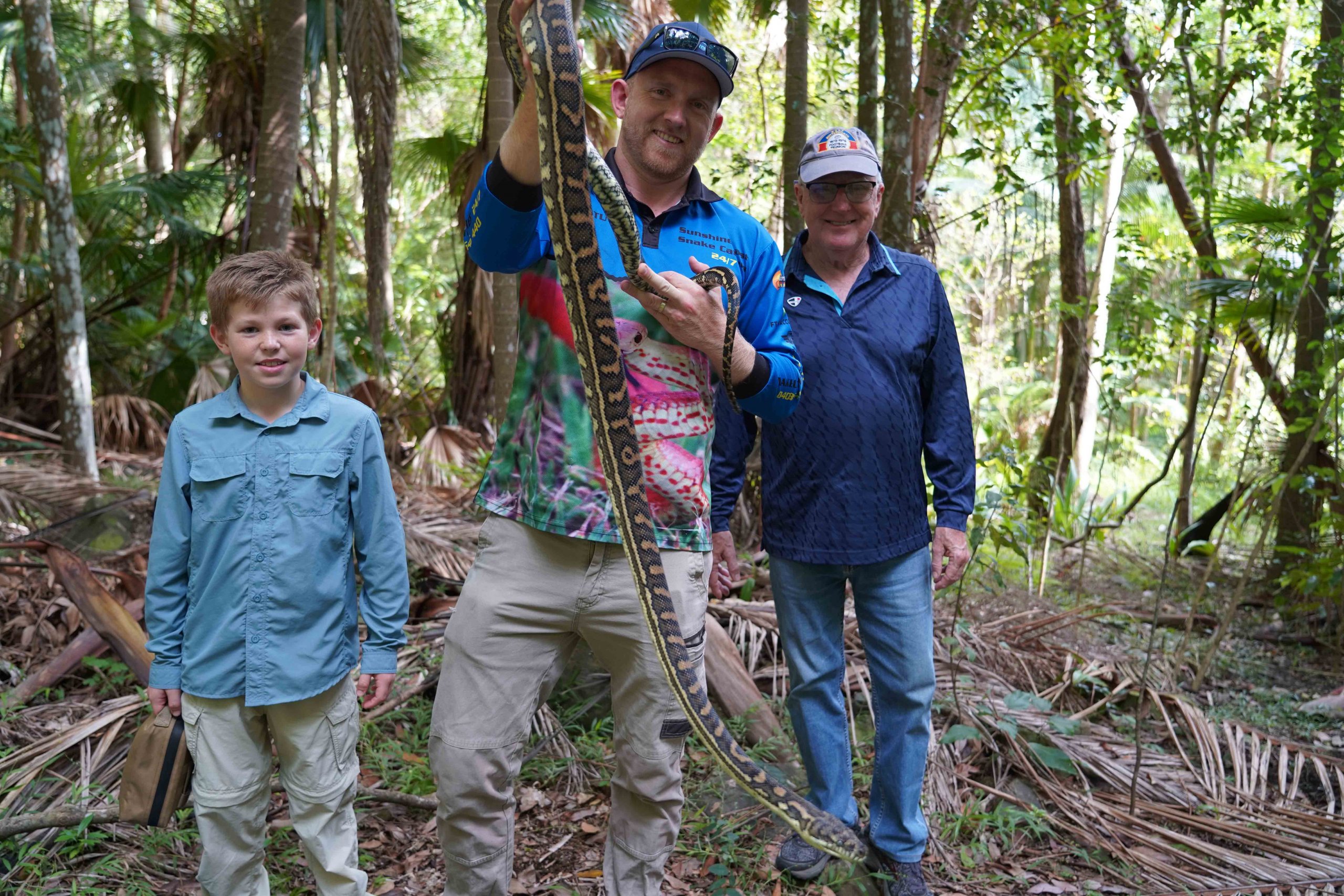 On a snake catching tour with Stu and the team holding carpet python