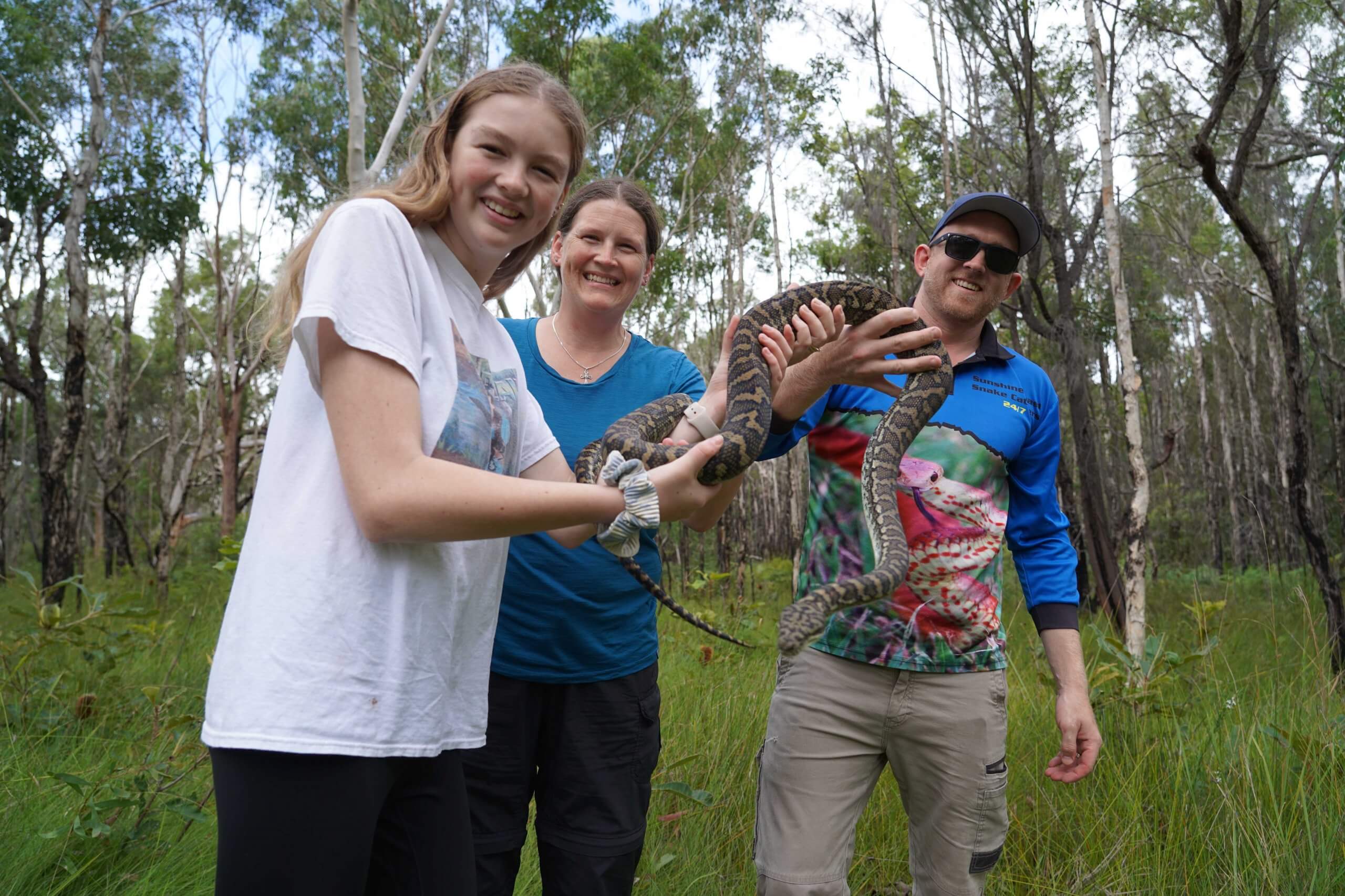 Mum and Daughter hold python on snake catching tour